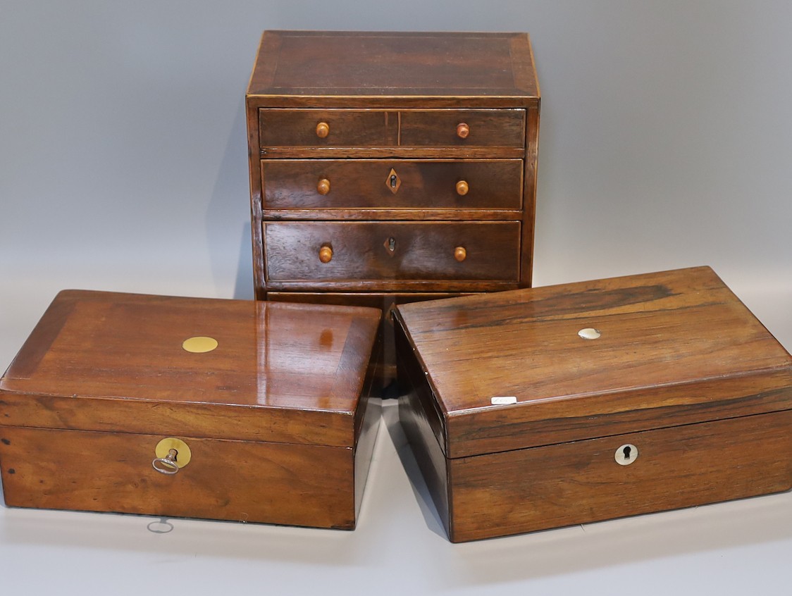 A Victorian rosewood jewellery casket, one other and a 19th century mahogany apprentice chest, height 25cm